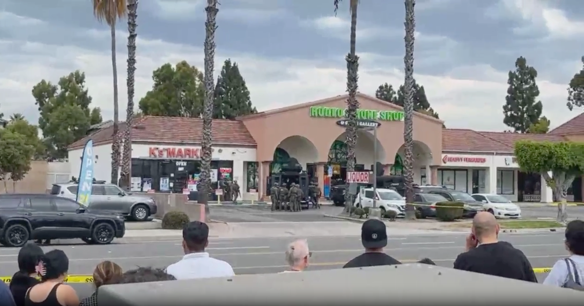 Man armed with blade and hatchet barricades himself inside Fullerton shop
